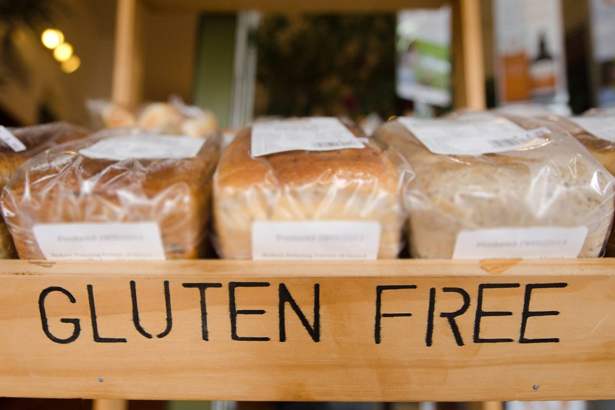 Packaged loaves of bread on a shelf labeled gluten free