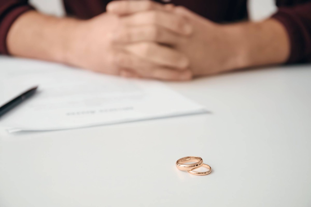 Wedding rings placed on a table during a quiet divorce discussion