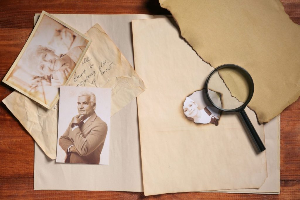 Cutouts of old brown paper and old pictures on top of brown table