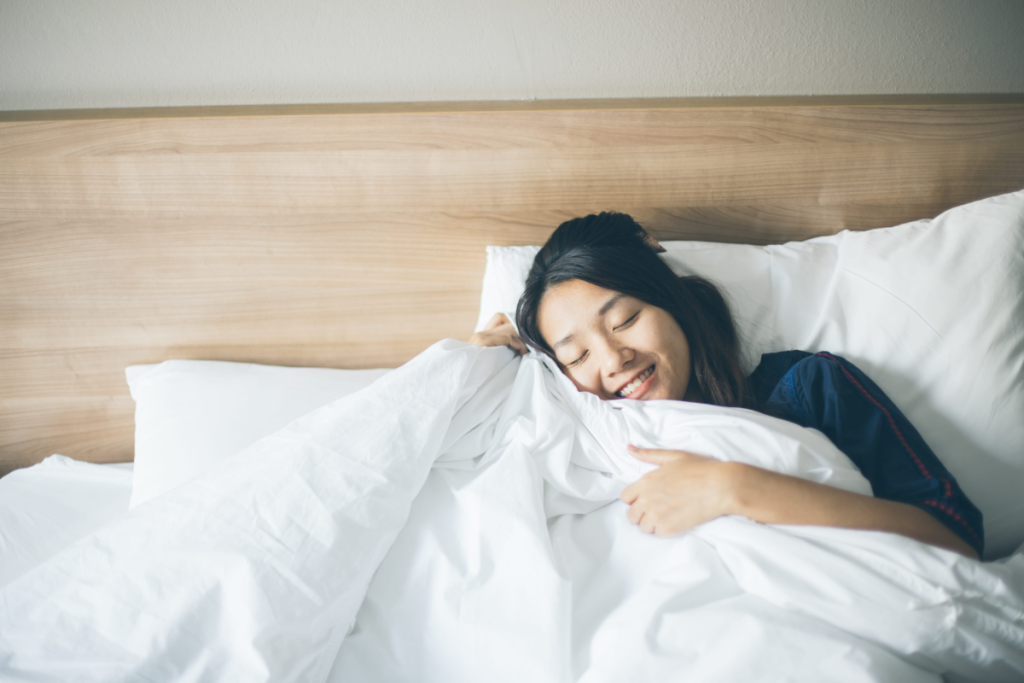 Person testing the comfort of a new mattress.